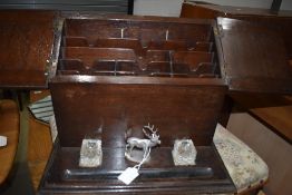 An oak cased stationery box with inkwells