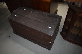 An antique dome top travel trunk