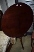 A 19th Century mahogany pedestal table of tilt top design, with turned column and triple splay legs