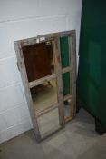 A pair of rustic doors, having mirror panes