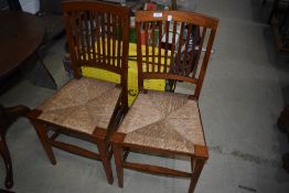 A pair of Arts and Crafts rush seated side chairs