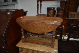 A traditional Priory style low occasional/coffee table having drop leaves