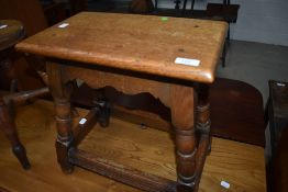 A traditional coffin stool style occasional table