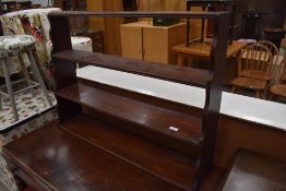 A Victorian mahogany open waterfall style shelf, width approx. 93cm