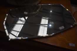 A frameless wall mirror