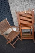 A set of four teak folding garden chairs