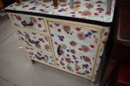 A metal side cabinet having floral decoration, very chintzy