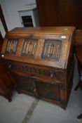 A priory style bureau having linen fold to flap