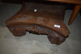 An antique carved wood stand