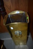 A vintage brass stick stand having lion mask handles