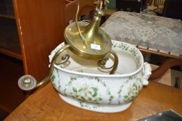 A reproduction footbath and brass ceiling light fitting