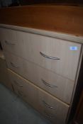 A beech laminate chest of drawers