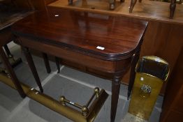 A 19th Century mahogany fold over tea table having reeded legs