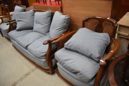 An early 20th stained frame continental style three piece suite having bergere canework back and