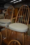 A pair of Ercol hoop and stick back dining chairs