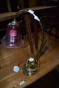 A brass and glass table lamp in the style of Adrian Sankey