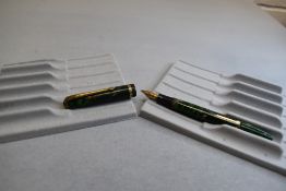 A Conway Stewart 12 leverfil fountain pen in green marble with single band to the cap having a