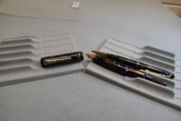 A Burnham 50 leverfill fountain pen and propelling pencil set in blue/ gold with single band to