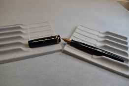 A Parker Duofold buttonfill fountain pen in black with two rings to cap having Parker Duofold G nib.