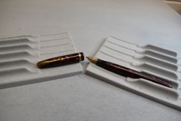 A Conway Stewart 12 leverfill fountain pen in red marble with single band to the cap having a Conway
