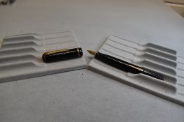 A Burnham leverfill fountain pen in black with one broad band to the cap having a Burnham Medium S20