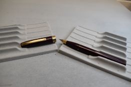 A Sheaffer Imperial III Touchdown plunger fill fountain pen in burgundy with a broad band to the cap