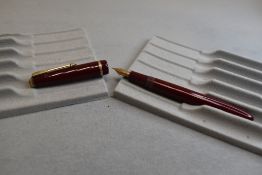 A Parker Slimfold fountain pen in burgundy with single decorative band to cap with Parker 5 nib.