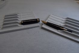 A Sheaffer flat top fountain pen in black with single band to ring top having Sheaffer Lifetime nib.