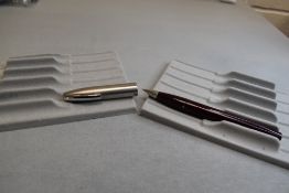 A Sheaffer Imperial II Deluxe Touchdown plunger fill fountain pen in burgundy with a brushed steel