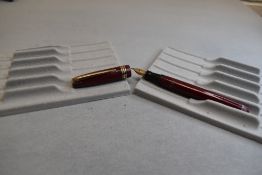 A Mabie Todd & Co Swan Leverless twist filler, in maroon with two narrow and one broad band to cap