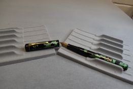 A Conway Stewart 475 leverfil fountain pen in green/black marble a Conway Stewart 14k nib. Approx