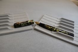 A Burnham 'The Burnham' leverfill fountain pen in green marble with two narrow and one broad bands