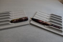 A Wyvern 60 leverfill fountain pen in pink marble having single narrow band to the cap. Approx 13.