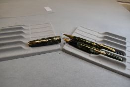 A Burnham 55 leverfill fountain pen and propelling pencil set in green marble with two narrow