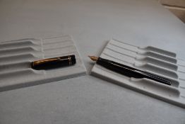 A Mabie Todd & Co Swan Leverless twist filler, in black with two bands to cap (cap missing screw