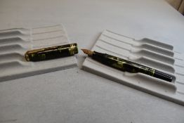 A Stephens 21 button fountain pen in green marble having Warrented nib. Approx 13cm