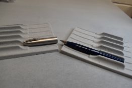 A Sheaffer Imperial II Deluxe Touchdown plunger fill fountain pen in blue with a brushed steel cap