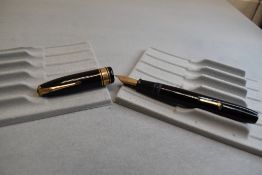 A Conway Stewart 100 leverfill fountain pen in black with two narrow a one broad band to cap