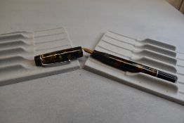 A Stephens 56 button fountain pen in gold/black marble having Stephens 56 nib. Approx 12.9cm