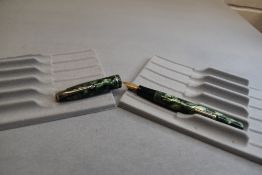 A Conway Stewart 75 leverfil fountain pen in green marble with single band to the cap having a