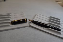 A Conway Stewart leverfil fountain pen in black with two narrow and one broad band to the cap having