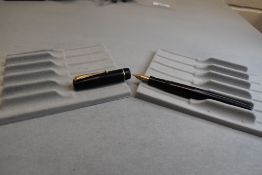 A Mabie Todd & Co Swan 6160 leverfil fountain pen in black with single narrow band to the cap having