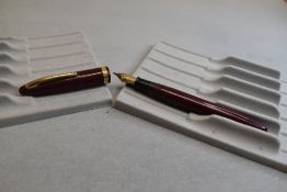 A Sheaffer Cadet plunger fill fountain pen in burgundy with a broad band to the cap having a