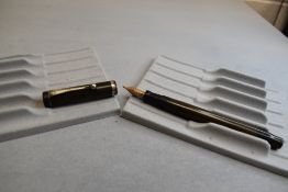 An early Parker Duofold button fill in BHR (discoloured) having Parker Duofold nib. Approx 13.5cm