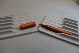 A Conway Stewart No92 stylo pen in orange. Approx 10.2cm