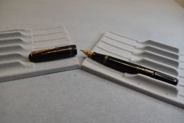 A Mabie Todd & Co Swan 6261 Self Filler Leverfill, in black with two bands to the cap and a Swan No2