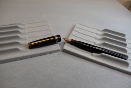 A Mabie Todd & Co Swan Leverless twist filler, in black with two narrow and one broad band to cap