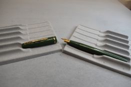 A Burnham vacuum fill fountain pen in green with single band to the cap having Osmiroid nib.