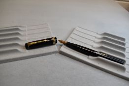 A Conway Stewart 388 leverfill fountain pen in black with one medium and two narrow bands to the cap