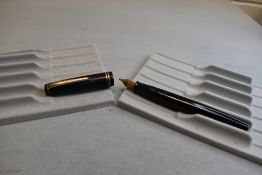 A Parker Victory button fill fountain pen in black with two narrow bands to the cap having a